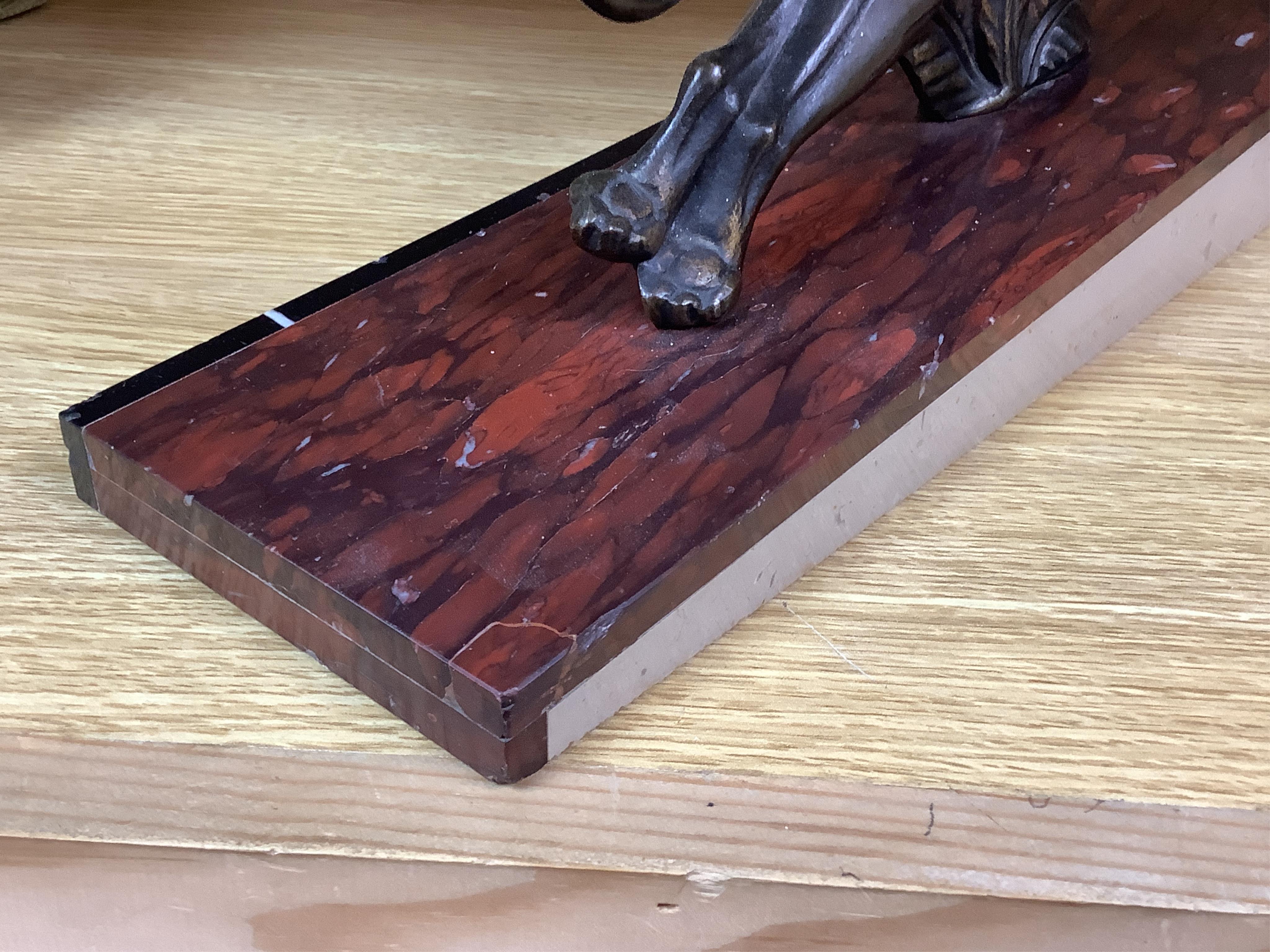 A French Art Deco bronze sculpture of a panther, raised on slanted base, 44cm wide